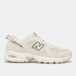 White New Balance 530 sneaker viewed from the side, showing N logo and chunky sole in beige/cream tones