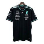 Black team polo jersey with teal white stripes on shoulders, featuring Mercedes-AMG Petronas logos and various sponsor graphics on the chest and sleeves.