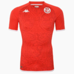 Red soccer jersey with white-trim sleeves and a circular team crest on the left chest, featuring a stylized emblem.