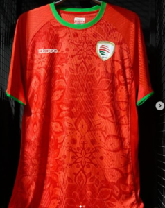 Red sports jersey with green collar and cuffs, featuring a crest on the left chest and Kappa logo on the right.