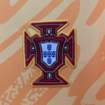 Embroidered Portugal national football team crest (FPF) in red, gold, and blue on an orange patterned fabric background.