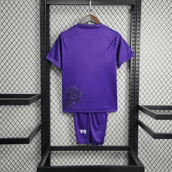 Purple Real Madrid shirt-and-shorts kit on a hanger, rear view