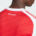 Back view of a person wearing a red Arsenal football jersey with a white collar and repeating pattern across the fabric, 'Arsenal' text near the neckline.
