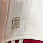 Close-up of white patterned fabric with a gold-bordered badge that reads 'AUTHENTIC LICENSED PRODUCT'.