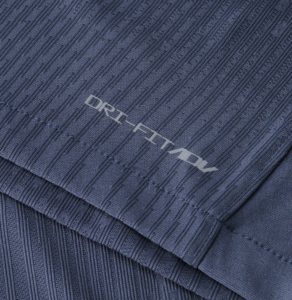 Close-up of navy knit fabric with DRI-FIT logo visible