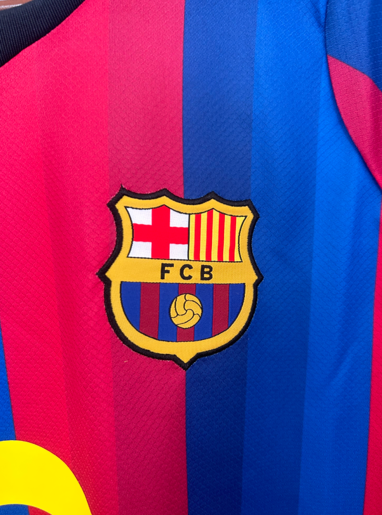 Screenshot2026-01-24at12.31.36-768x1035-1 | UAE SPORT STORE FC Barcelona crest on a red and blue striped jersey.