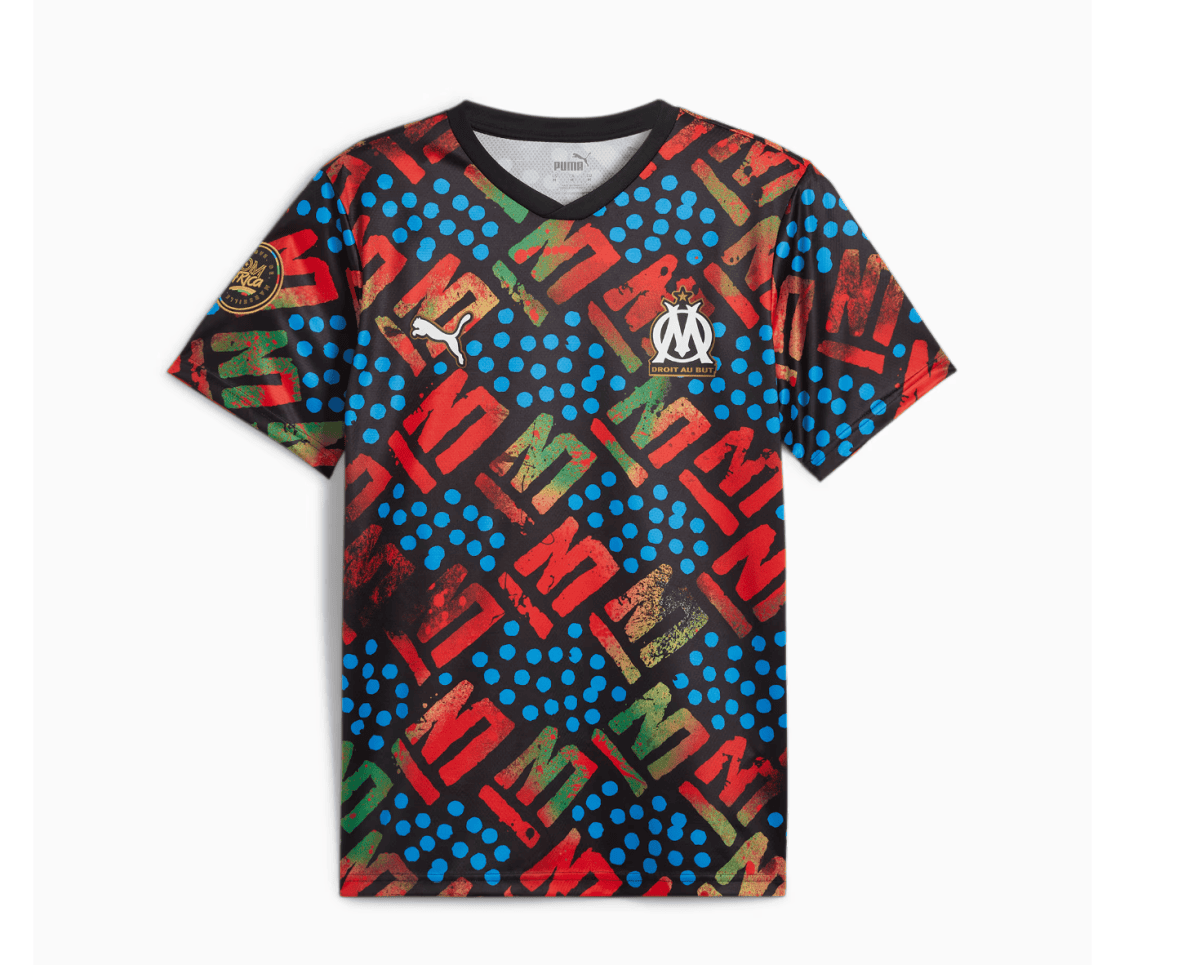 Bright, patterned football jersey featuring blue dots and red-green geometric shapes; has OM crest and Puma logo on chest.