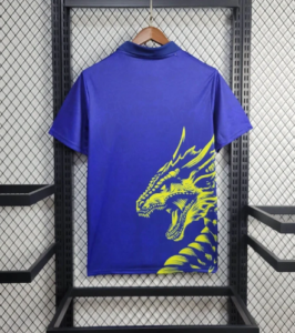 Screenshot_2024-06-24_205959 | UAE SPORT STORE Blue T-shirt with a neon yellow dragon graphic on the lower right, hung on a wooden hanger.