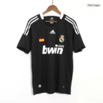 Black Real Madrid football jersey on a hanger with crest, Spanish flag patch, and bwin sponsor on the front.