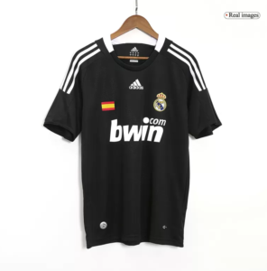 Screenshot_2024-06-27_021448 | UAE SPORT STORE Black Real Madrid football jersey on a hanger with crest, Spanish flag patch, and bwin sponsor on the front.