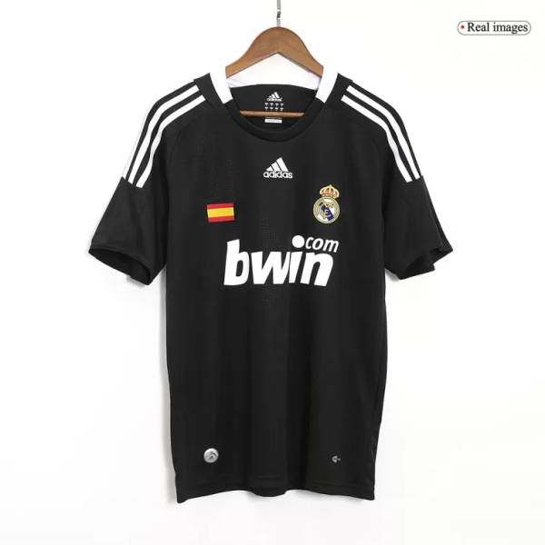 Black Real Madrid football jersey on a hanger with crest, Spanish flag patch, and bwin sponsor on the front.