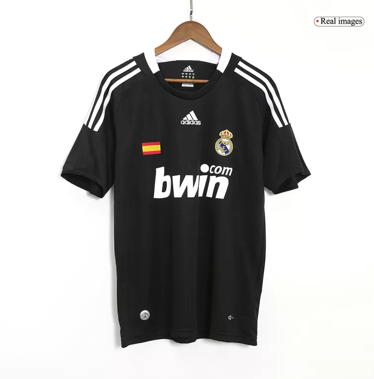Screenshot_2024-06-27_021448 | UAE SPORT STORE Black Real Madrid football jersey on a hanger with crest, Spanish flag patch, and bwin sponsor on the front.