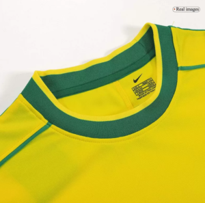 Bright yellow athletic shirt with a green crew neck trim and visible brand tag at the neck area.
