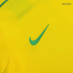 Bright yellow Nike athletic shirt fabric with a green swoosh logo close-up on the chest area.