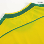 Close-up of a yellow jersey with a green collar and seam details along the shoulder area.