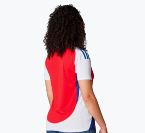 Person wearing a red and white sports jersey seen from behind, with curly hair.