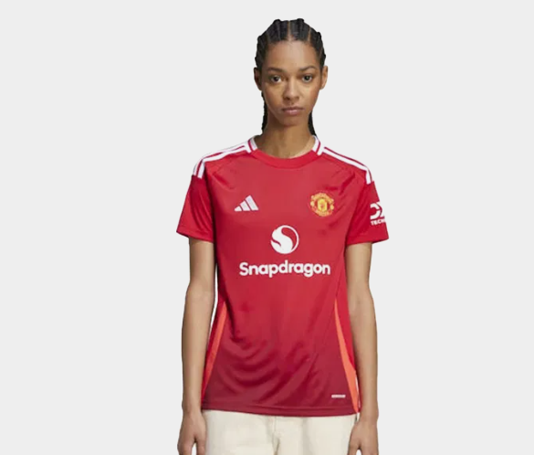 Female model wearing a red Manchester United football jersey with Snapdragon sponsor, front view against a light background.