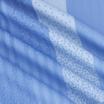 Close-up of blue textured fabric with folded layers and a dotted weave pattern.
