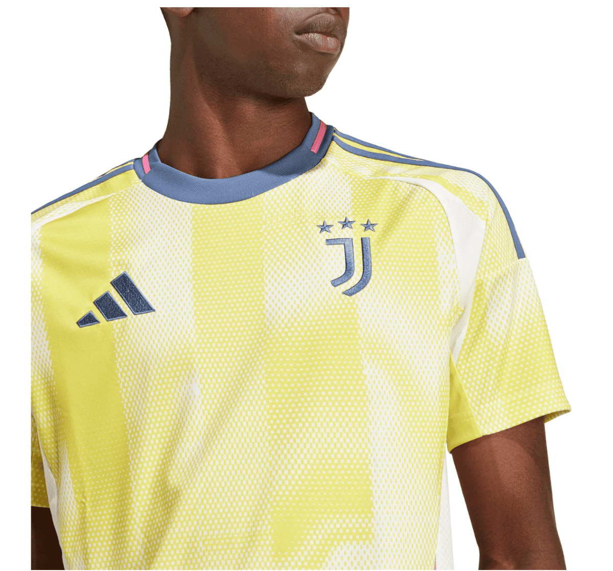 Close-up of a person wearing a yellow Juventus soccer jersey with the club crest showing four stars, and the Adidas logo on the chest.