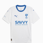 White soccer jersey with blue crew neck and a subtle geometric pattern, featuring the blue Savvy Games Group sponsor across the chest and a blue club crest on the left chest with Puma branding on the sleeves.