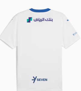 Screenshot_2024-09-04_203334 | UAE SPORT STORE Back of a white jersey with Riyadh Bank logo in Arabic near the top back and a SEVEN logo toward the bottom of the shirt, blue collar accents.
