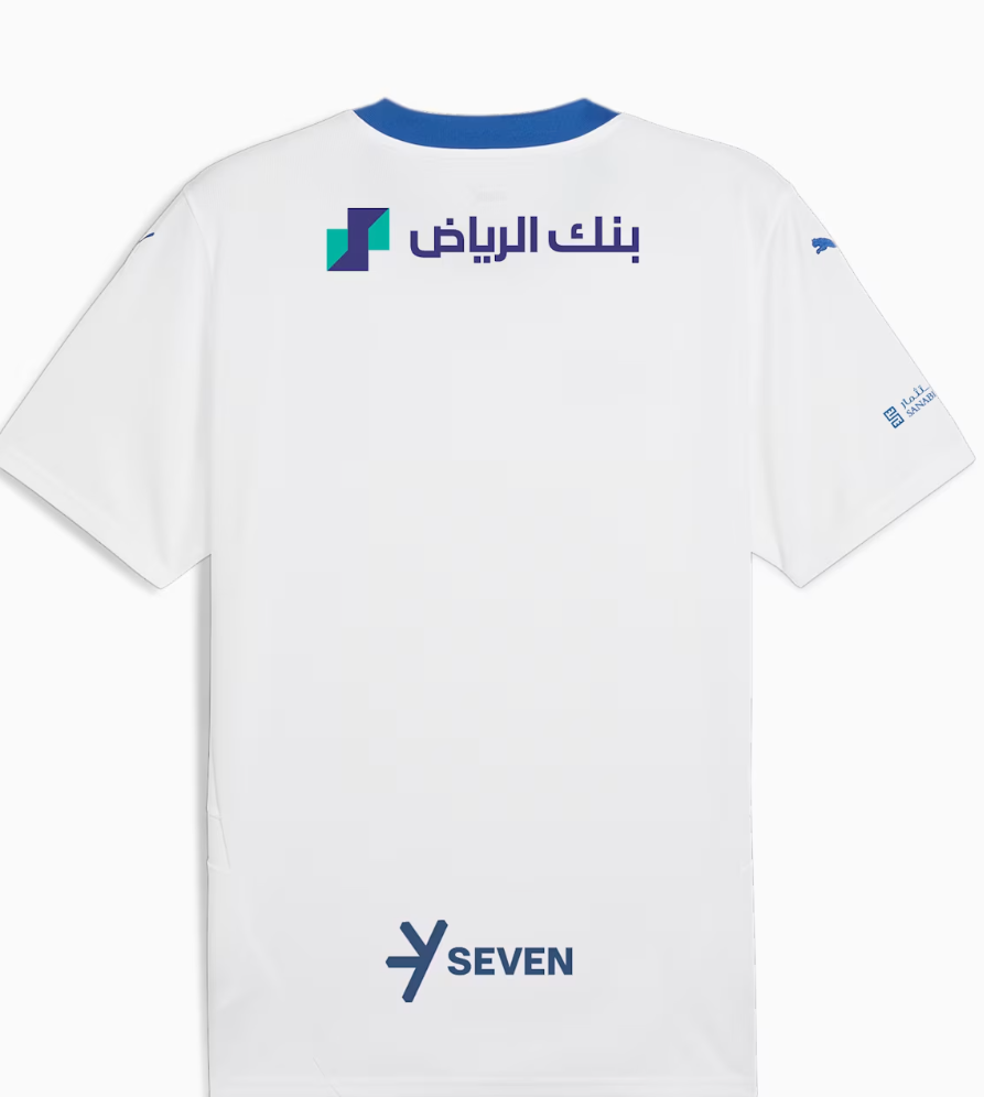 Screenshot_2024-09-04_203334 | UAE SPORT STORE Back of a white jersey with Riyadh Bank logo in Arabic near the top back and a SEVEN logo toward the bottom of the shirt, blue collar accents.