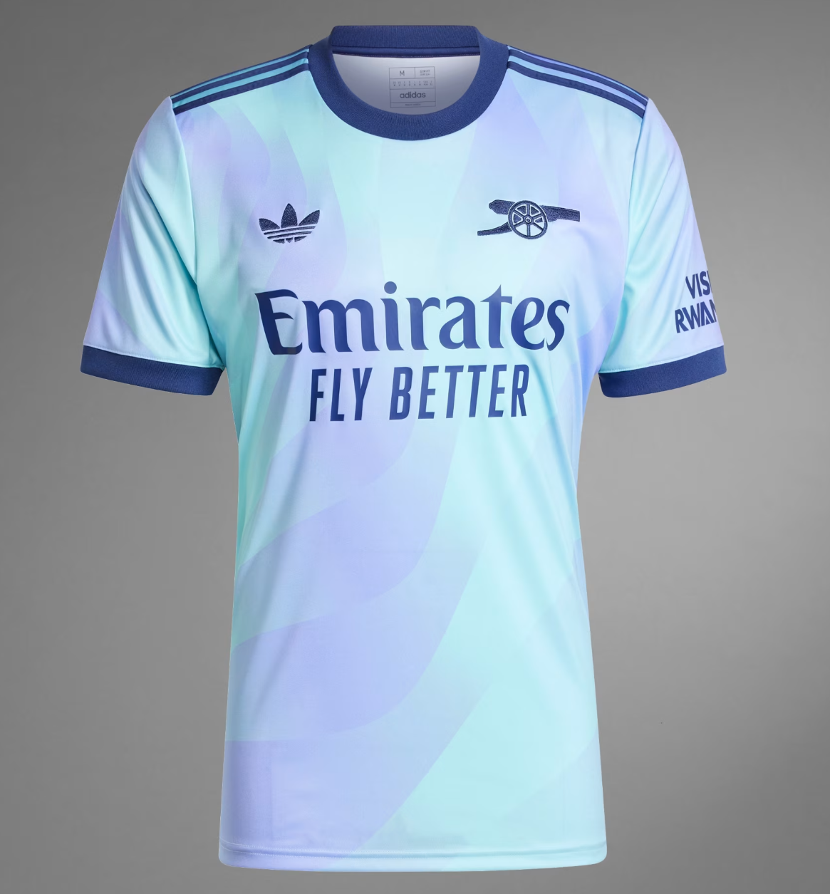 Screenshot_2024-09-18_194453_686678cf-dcc5-4ae3-a155-2ecfce0e3db3 | UAE SPORT STORE Light blue gradient football jersey with Emirates Fly Better sponsor, Adidas stripes on shoulders, and a cannon emblem on the chest.