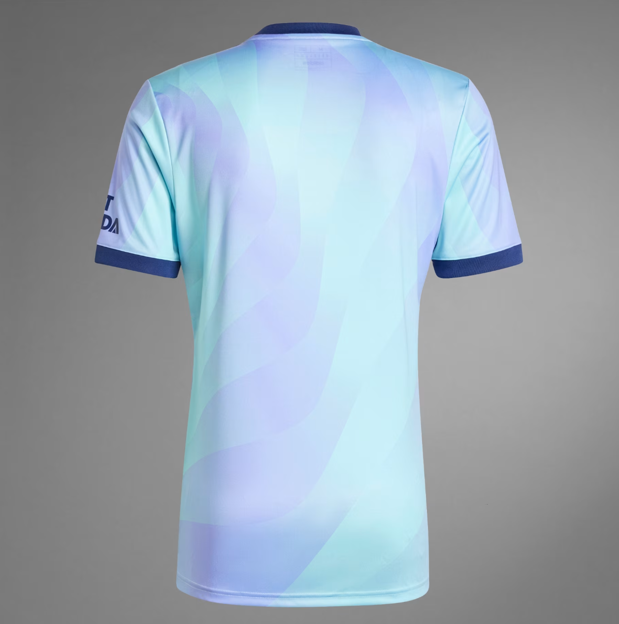 Screenshot_2024-09-18_194503_6664df22-62c5-4f5f-b6d2-36d2a14af5d3 | UAE SPORT STORE Back view of a pastel blue and teal sports jersey with purple swirl pattern and dark blue collar and cuffs