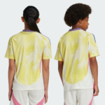 Two children are shown from behind wearing bright yellow mesh sports jerseys with pink and white accents.