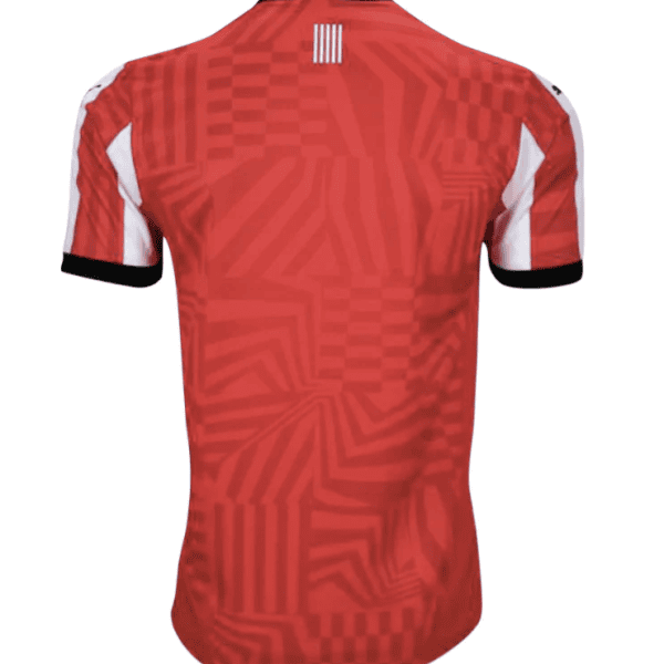 Red geometric-patterned short-sleeve soccer jersey viewed from the back, with a black collar and black cuffs on the sleeves.