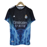 Blue Real Madrid football jersey on a hanger, featuring the Emirates Fly Better sponsor and club crest against a starry pattern.