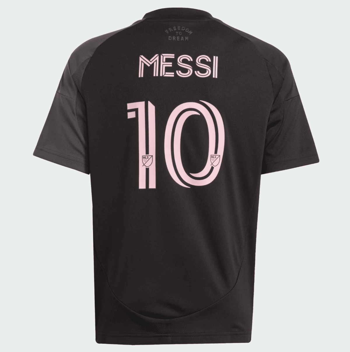 Black Messi jersey back view with pink number 10 and name, MLS logos on digits, and 'Freedom to Dream' text at the neck area