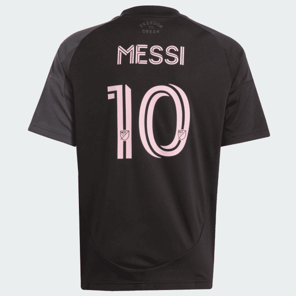 Black Messi jersey back view with pink number 10 and name, MLS logos on digits, and 'Freedom to Dream' text at the neck area