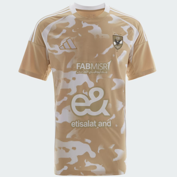 Beige camouflage-pattern football jersey with white accents, team crest on the left chest and large sponsor logos across the front (Etisalat).