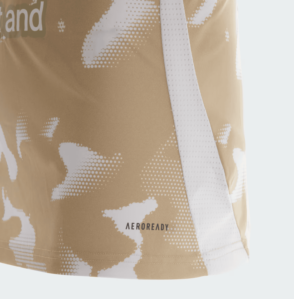 Screenshot_2025-01-14_174500 | UAE SPORT STORE Close-up of a beige bag with white dotted camouflage pattern and a white strap across it; small 'AEROREADY' label visible.