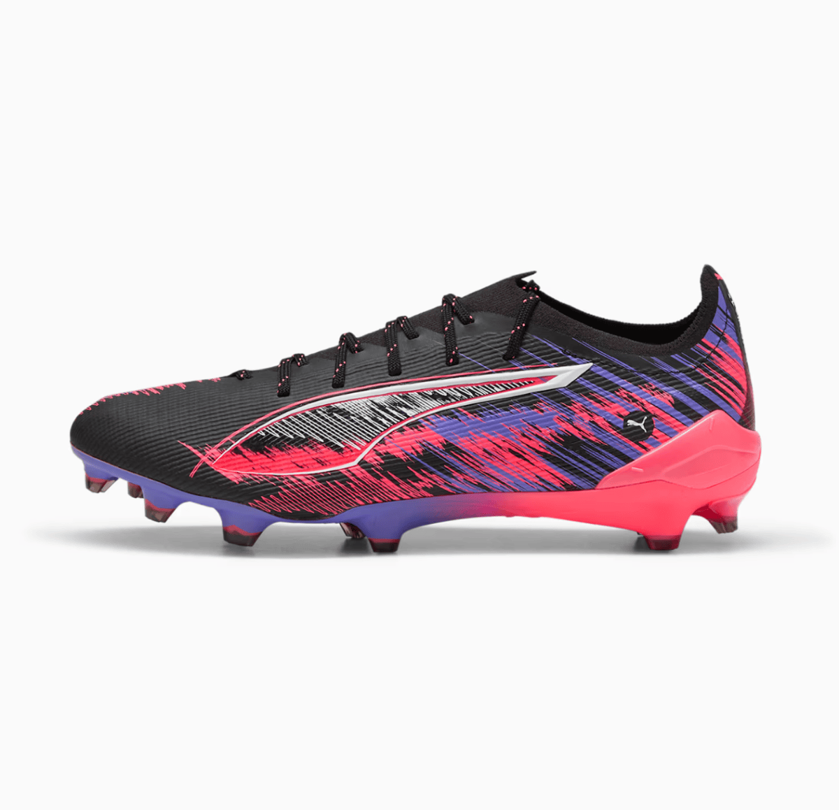 Black soccer cleat with a pink–purple brushstroke pattern and a bright pink heel, featuring a white side emblem for contrast.
