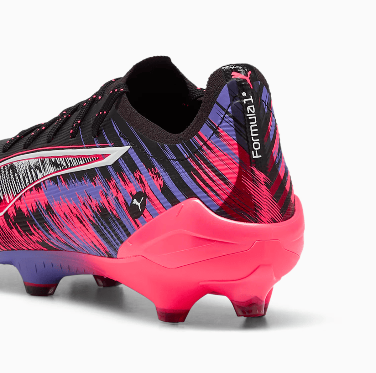 Puma soccer cleat with neon pink outsole and purple-black patterned upper, Formotion logo on the heel.