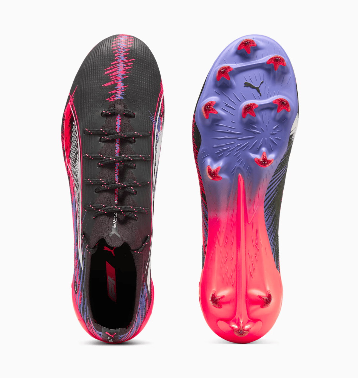 Pair of black and pink Puma soccer cleats shown from the top (left) and bottom (right) with a purple outsole and pink studs.
