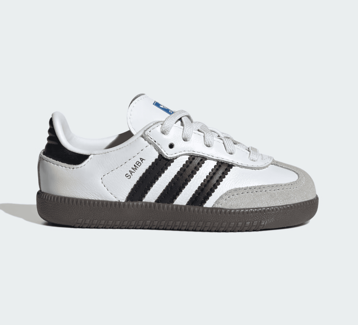 White Adidas Samba-style sneaker with black stripes, white upper, beige suede toe cap, and brown sole, side view
