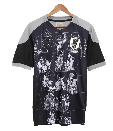 Dark short-sleeve sports jersey with a grayscale anime character grid and a Japan JFA patch, shown on a hanger.