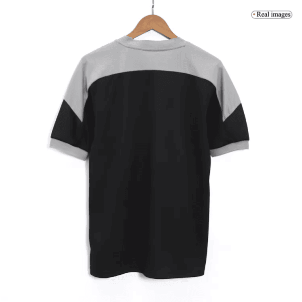 Back view of a color-block short-sleeve shirt on a hanger: gray yoke and sleeves with a black body.