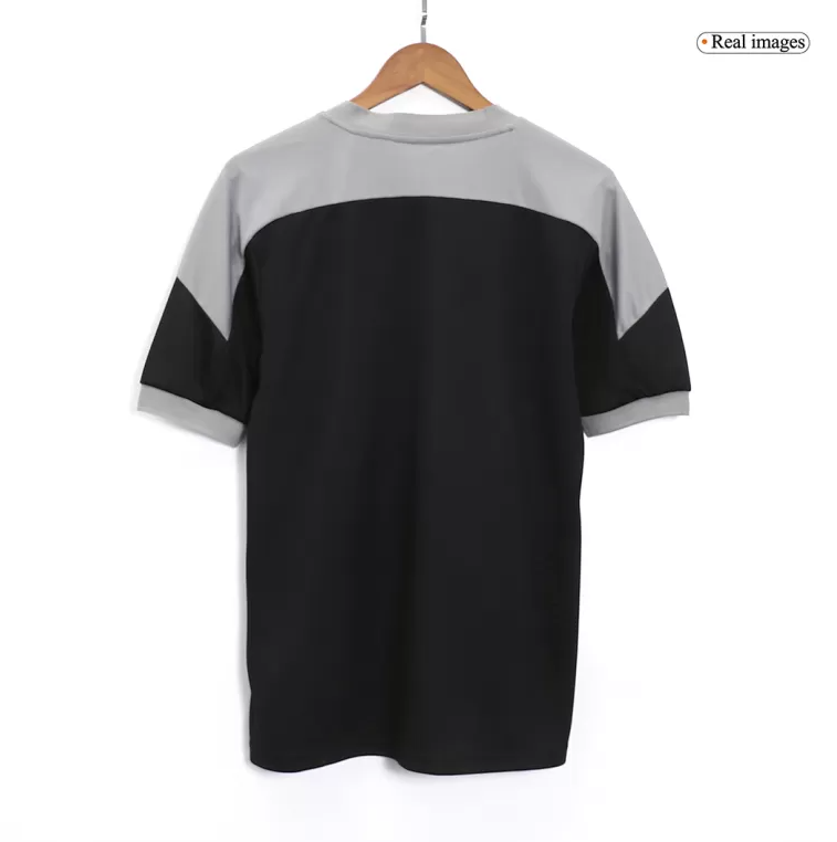 Screenshot_2025-03-05_231046 | UAE SPORT STORE Back view of a color-block short-sleeve shirt on a hanger: gray yoke and sleeves with a black body.