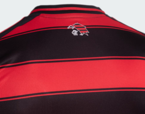 Back of a red and black striped polo shirt with a small white crest on the upper back.
