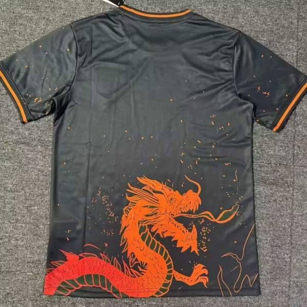 Back of a black athletic jersey with an orange dragon graphic near the bottom-left and orange trim on the sleeves.