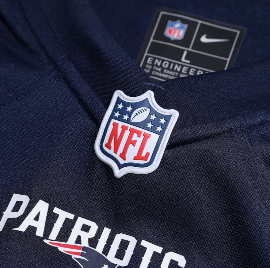 Screenshot_2025-04-17_053034 | UAE SPORT STORE NFL shield pin on a dark blue fabric with 'PATRIOTS' lettering visible below.