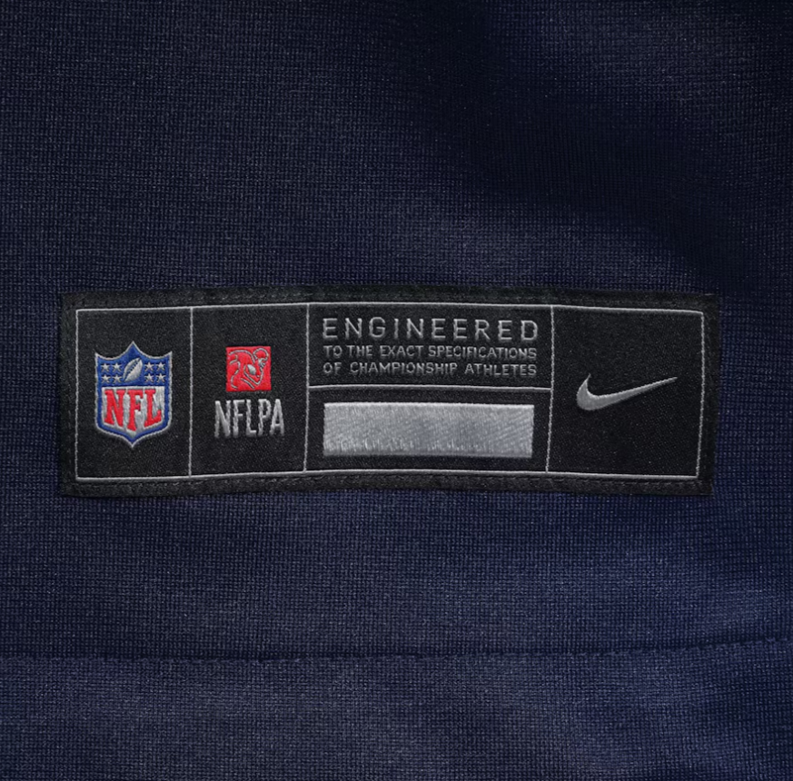 Screenshot_2025-04-17_053043 | UAE SPORT STORE Label on navy fabric featuring NFL and NFLPA logos, the Nike swoosh, and the phrase 'Engineered to the exact specifications of championship athletes'.