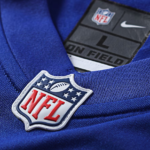 Close-up of a blue NFL jersey showing the NFL shield patch near the collar.