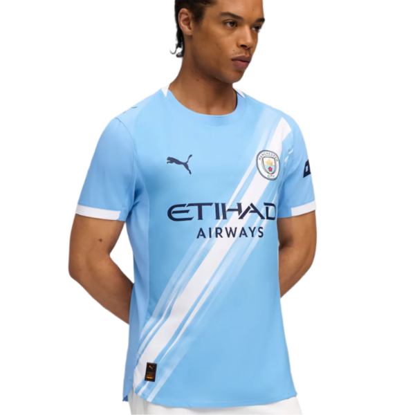 Manchester City light-blue jersey with diagonal white stripes, crest, Puma logo, and Etihad Airways sponsor.