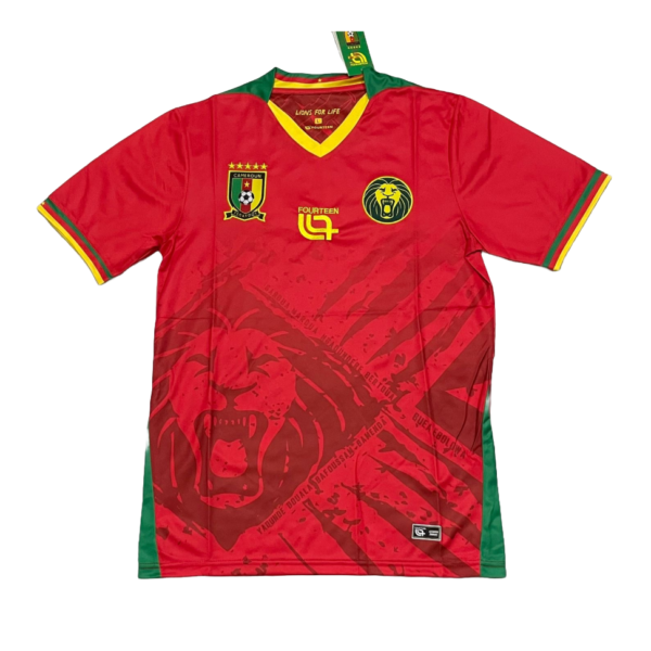 Red Cameroon national football jersey with green/yellow trim, crest on left chest, lion emblem on right, and 'Fourteen 04' detail on chest.