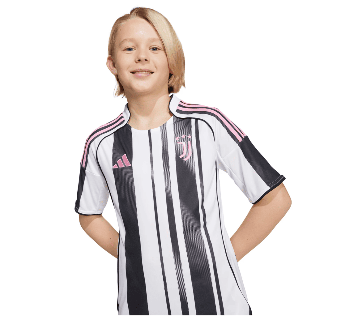 Smiling child wearing a black-and-white striped Juventus soccer jersey with pink details, hands on hips against a white background.